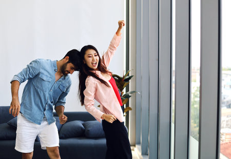 Happiness young couple dancing activities for working from home at home and stay at home.