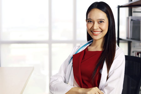 Portrait attractive woman doctor holding COVID-19 vaccine for use in clinic or hospital room.