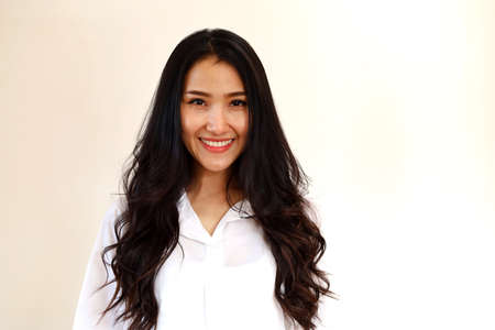 Happiness beautiful young Asia woman smile portrait on wall texture background.の写真素材
