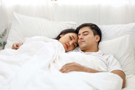 Happiness young couple lover sleeping and relaxation on bedroom.の写真素材