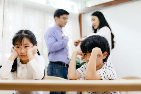 Family problems concept, father and mother quarreling in the house so causing children to feel bad.の写真素材