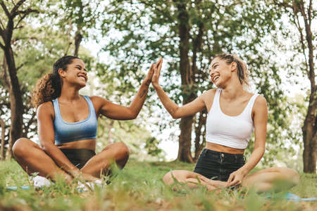 Happiness young woman friendship enjoyment and playing yoga at garden park.の写真素材