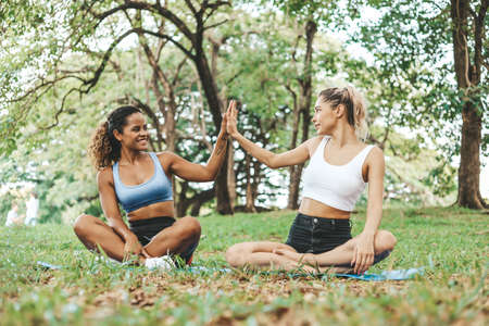 Happiness young woman friendship enjoyment and playing yoga at garden park.の写真素材