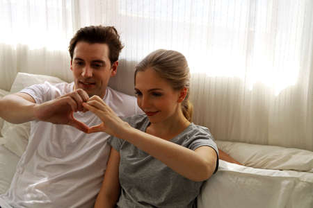 Happiness young couple having fun with their favorite dog at home.の写真素材