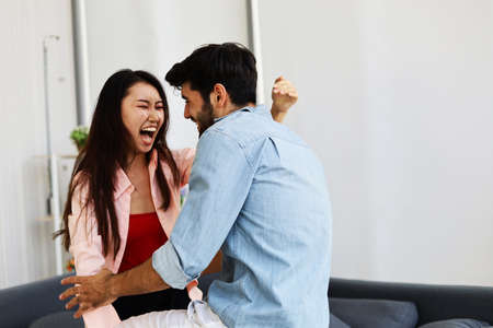 Happiness young couple having fun and dancing for stay home from protection corona virus.の写真素材
