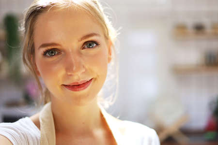 Beautiful young woman selfie portrait and cooking food at kitchen.の写真素材