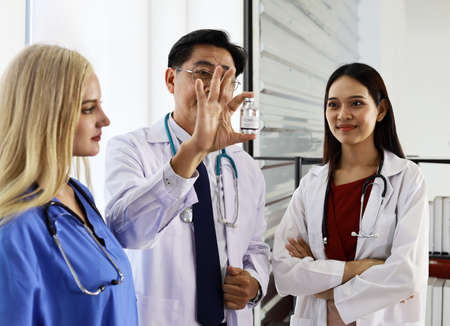 Happiness teamwork doctor talking and discuss in hospital.の写真素材