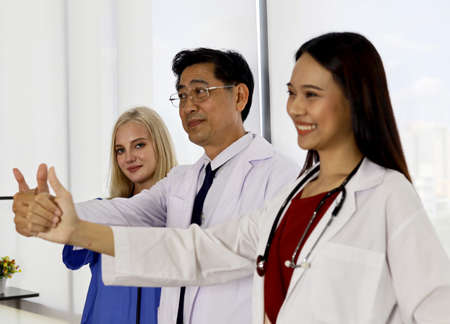 Happiness teamwork doctor talking and discuss in hospital.の写真素材
