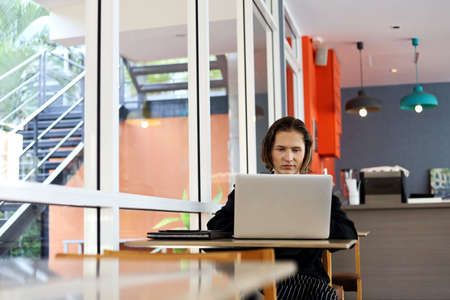 Coffee shop owner presenting a store on social media at coffee cafe.の写真素材