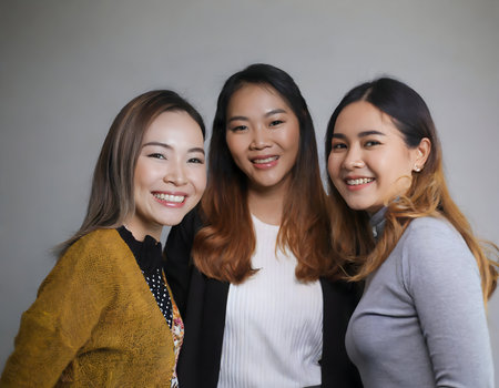 Three American Women with a beard smiling happily in a studio, fashion and lifestyle on digital art concept.の素材