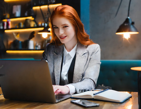 Close up Portrait of Beautiful young businesswoman working with laptop at cafe studio.の素材