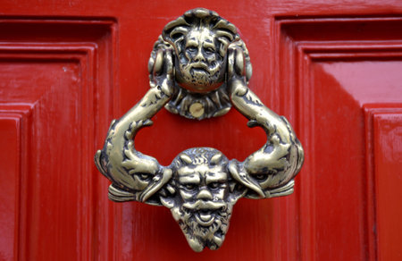 Old door knocker and red background