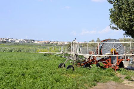 andscape with trees with agricultural equipment  and cloudy skyのeditorial素材