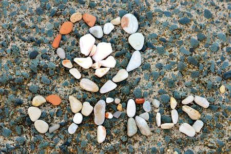 Written pattern of sea shells and stones on rock from Cyprusの写真素材