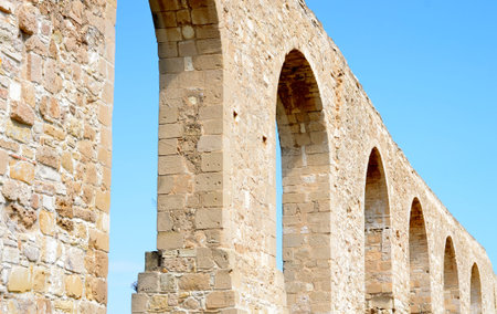 Ruins of old Kamares aqueduct from Cyprus with blue skyの写真素材