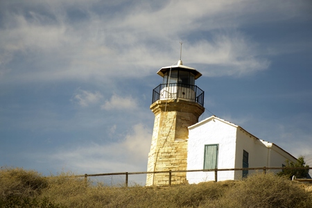 Outdoor architecture of an old lighthouse in Cyprus and cloudy blue skyの写真素材