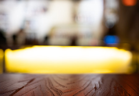 blurred defocused bartender counter abstract background with wooden tableの写真素材