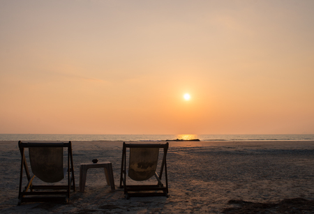 Beach chair on the beach with sun set lightの写真素材