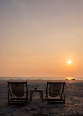 Beach chair on the beach with sun set lightの写真素材