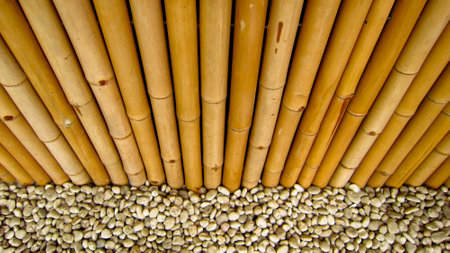 Lines of bamboo fence with white stonesの写真素材
