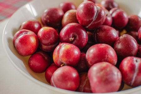 Red plums on the table