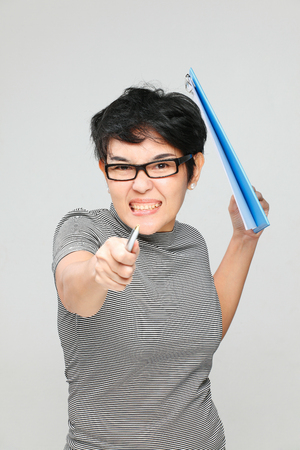 unhappy woman pointing the pen to the cameraの写真素材