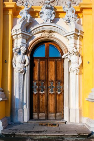 Richly ornamented door with cupids and atlants at the baroque Wilanow Royal Palaceのeditorial素材