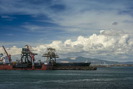 Loading commercial ship in Piombino industrial harborの写真素材