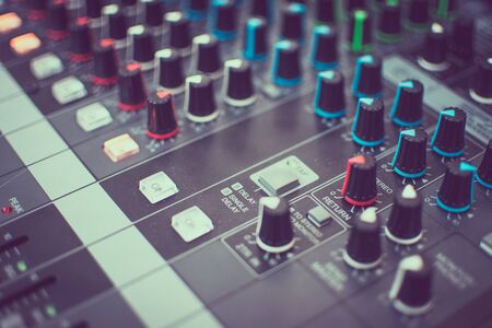 Sound mixer. Professional audio mixing console with lights, buttons, faders and sliders.の写真素材