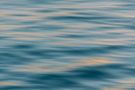 Blurry sunset reflection on deep blue sea. Minimal abstract summer holiday concept.の写真素材