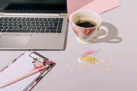 Home office set up with coffee, laptop, and spring accessories. Work from home concept