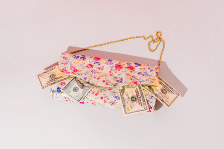 Floral handbag with money spilling out.Spring shopping concept.