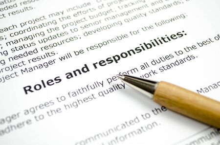 Roles and responsibilities with wooden penの写真素材