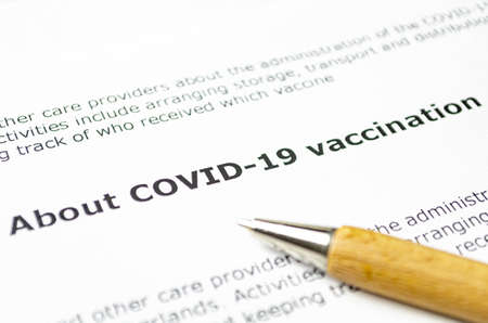 About COVID-19 vaccination with wooden penの写真素材