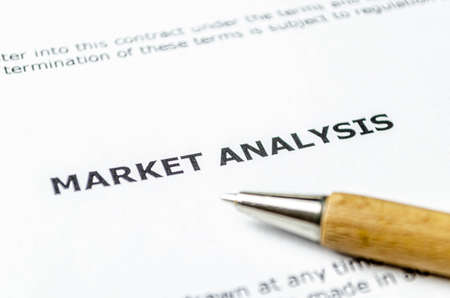 Market analysis with wooden penの写真素材