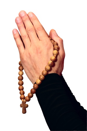 Wooden rosary with a cross hanging on his armsの写真素材