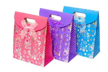 three multi-colored cardboard gift pack with an internal handleの写真素材