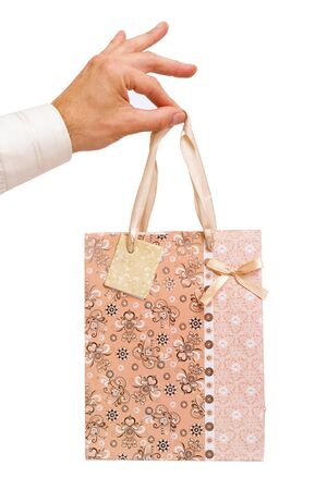 man's hand holding a bag with a giftの写真素材