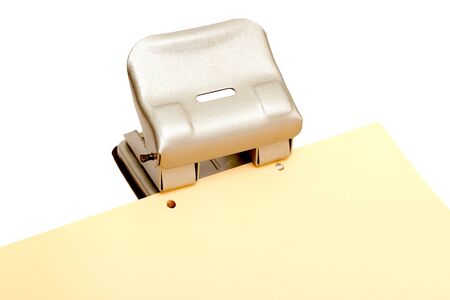 iron punch makes a hole in a sheet A4の写真素材