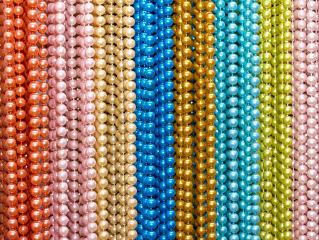 multi-colored beads of various sizes and shapes on the wallの写真素材