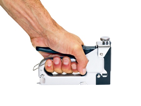 staple gun  in the man's hand on a white background の写真素材