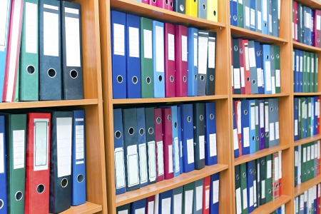 file folders, standing on the shelves in the backgroundの写真素材
