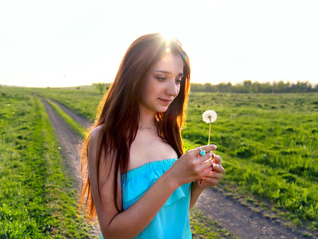Portrait of a young beautiful girl outdoors. Summer colors.の写真素材