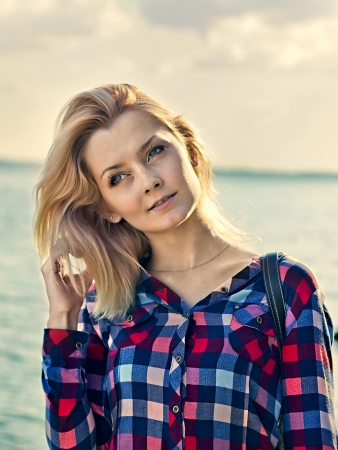 Portrait of a young beautiful sensual blonde girl outdoorsの写真素材