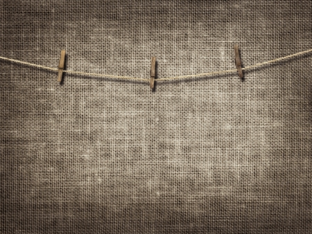 clothesline with clothespins on linen backgroundの写真素材