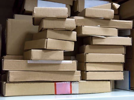 stack of small cardboard boxes on a shelfの写真素材
