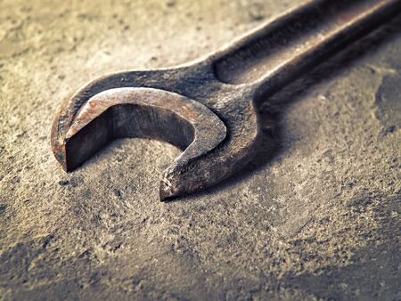 Old rusty wrench close-up in vintage styleの写真素材
