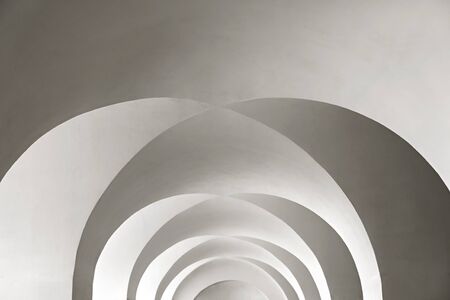 white arched ceiling with geometric shadows as backgroundの写真素材