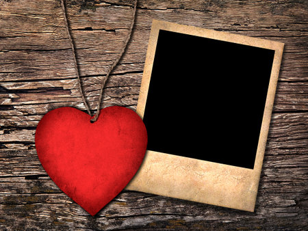 red paper heart and old photo  on the wooden backgroundの写真素材