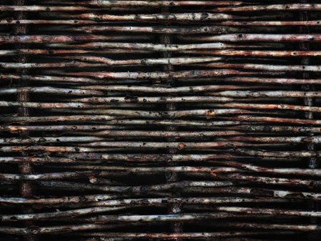 old vintage wicker fence made of willow twigs close up as a background or web banner